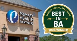 Exterior view of a health clinic with the 'Primary Health Partners' sign and blue circular logo beside it, plus a large green and gold 'Best in BA 2026 Winner' badge overlay.